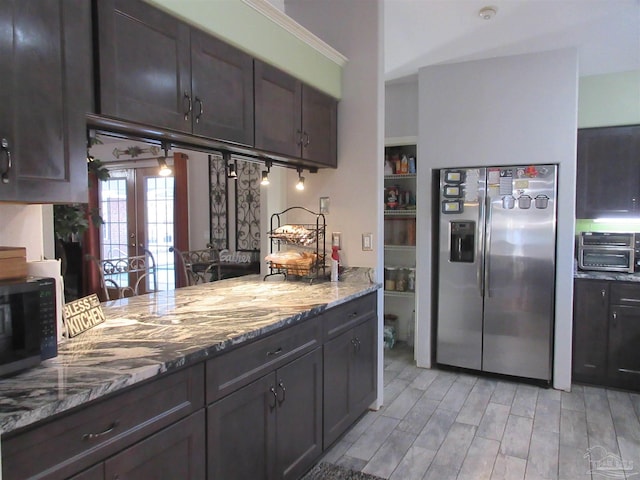 kitchen featuring french doors, dark brown cabinets, stainless steel fridge, light stone countertops, and light hardwood / wood-style floors