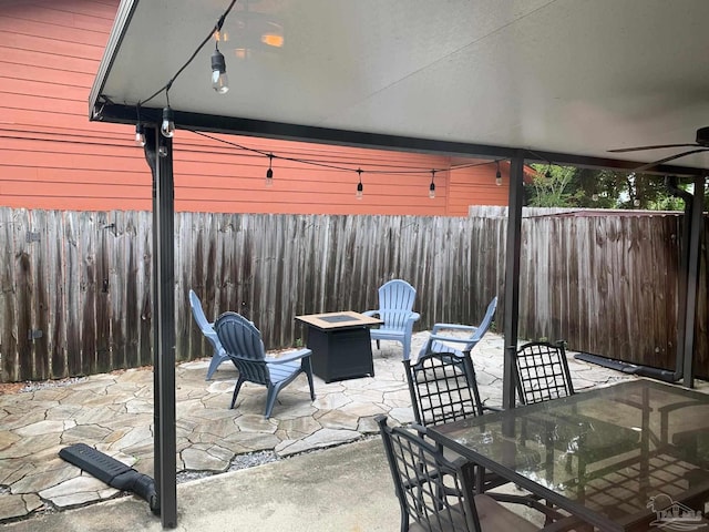 view of patio / terrace featuring an outdoor fire pit