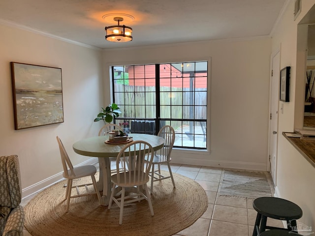 tiled dining area featuring crown molding