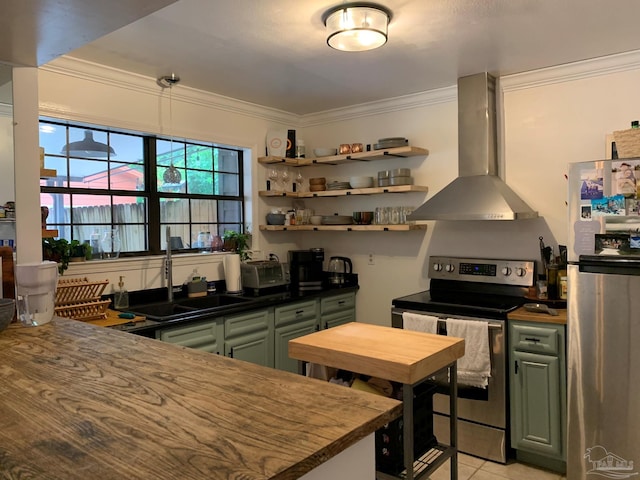 kitchen featuring appliances with stainless steel finishes, light tile patterned floors, range hood, sink, and green cabinets