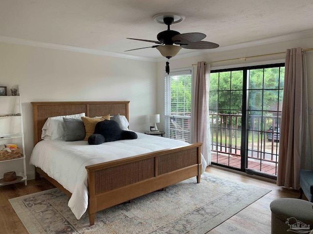 bedroom with ornamental molding, hardwood / wood-style floors, ceiling fan, and access to exterior