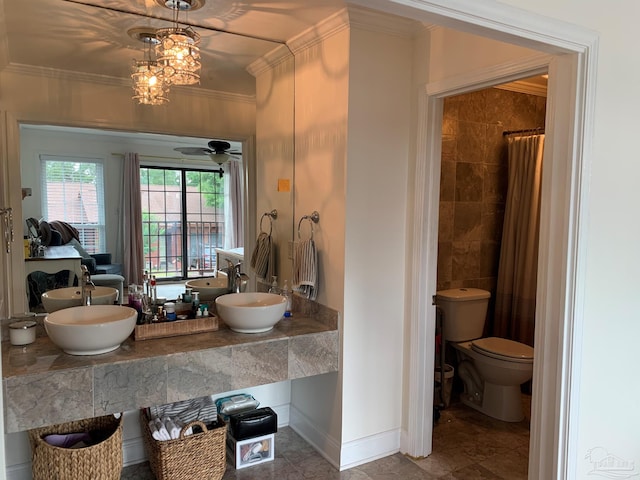 bathroom featuring ceiling fan with notable chandelier, walk in shower, crown molding, vanity, and toilet