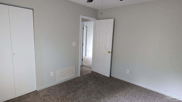 unfurnished bedroom featuring carpet floors, ceiling fan, and a closet