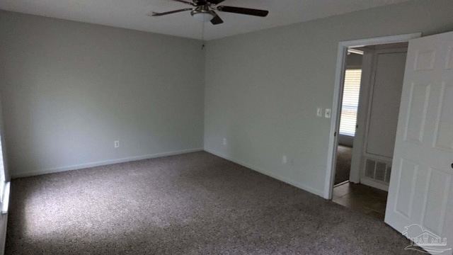 spare room featuring ceiling fan and carpet floors