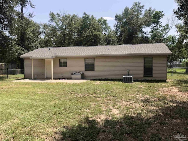 rear view of house with a lawn, a patio, and central air condition unit