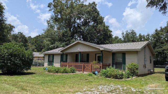 ranch-style house with a front yard and covered porch