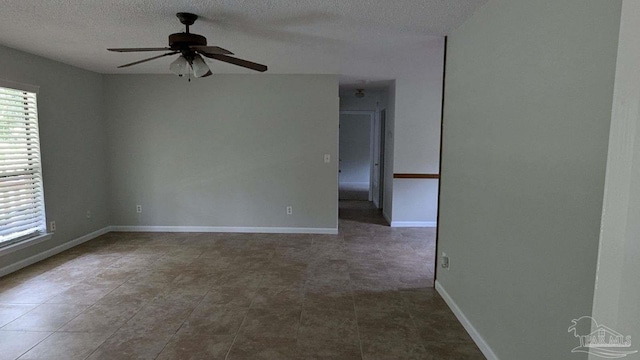 empty room featuring a textured ceiling and ceiling fan