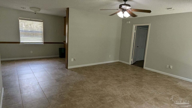 empty room featuring light tile patterned floors and ceiling fan