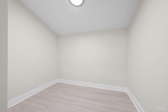 empty room featuring light wood-type flooring and baseboards