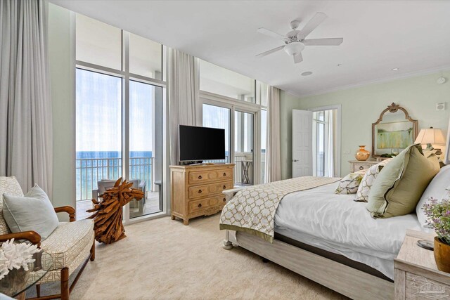 carpeted bedroom featuring ceiling fan, crown molding, and access to outside