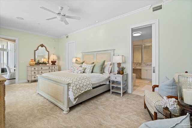 carpeted bedroom featuring ceiling fan, crown molding, and ensuite bath