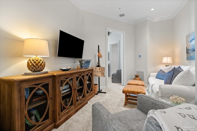 living room with ornamental molding and light colored carpet