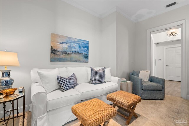 living room featuring hardwood / wood-style flooring, a chandelier, and ornamental molding