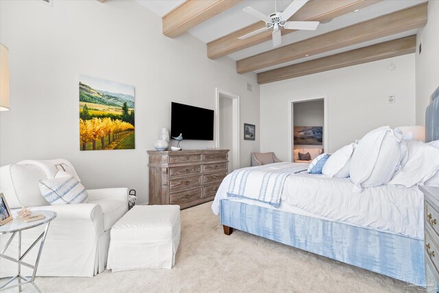 carpeted bedroom featuring beam ceiling and ceiling fan