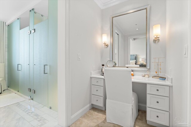 bathroom featuring vanity, ornamental molding, and an enclosed shower