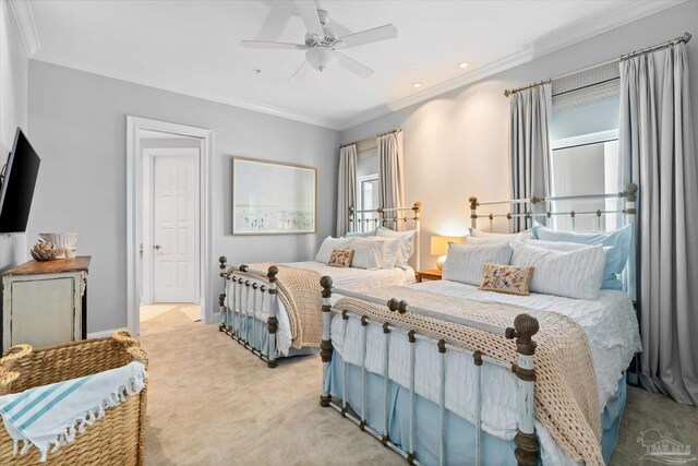 carpeted bedroom featuring crown molding and ceiling fan