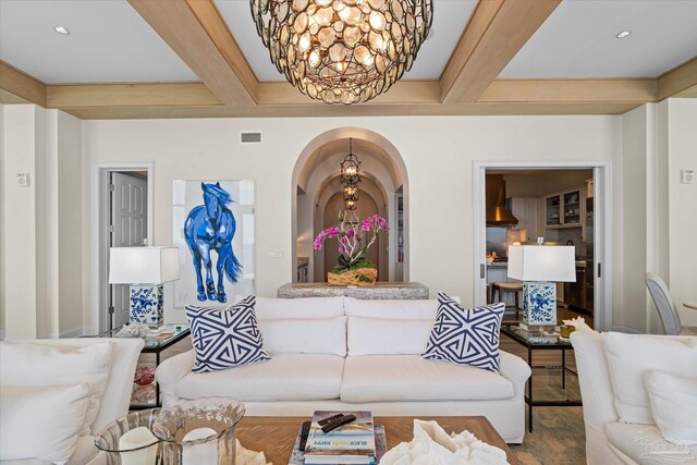 living room featuring a notable chandelier and beam ceiling