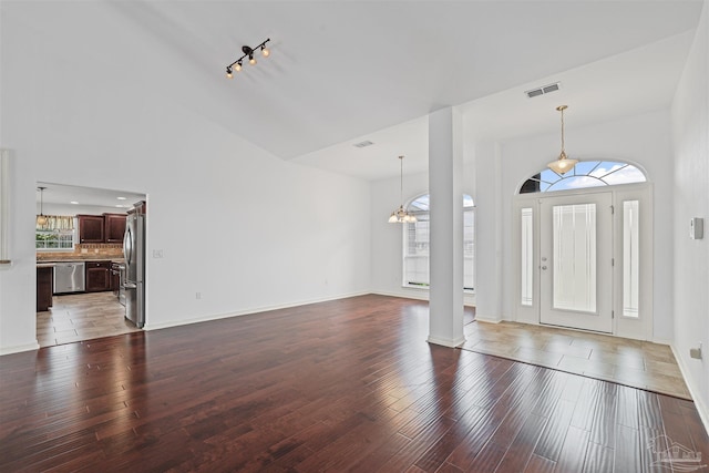 4810 Endeavor Ct, Milton, FL 32570 - foyer entrance with wood finished floors, baseboards, a high ceiling, and a chandelier