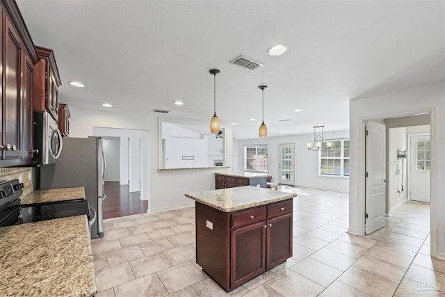 4810 Endeavor Ct, Milton, FL 32570 - kitchen with electric stove, a kitchen island, stainless steel microwave, baseboards, and decorative light fixtures