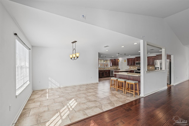 4810 Endeavor Ct, Milton, FL 32570 - living area with a chandelier, lofted ceiling, baseboards, and recessed lighting