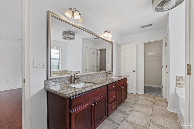 4810 Endeavor Ct, Milton, FL 32570 - full bathroom featuring double vanity, a walk in closet, a tub, and baseboards