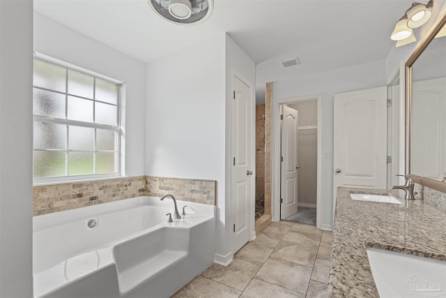 4810 Endeavor Ct, Milton, FL 32570 - full bathroom with a bath, double vanity, a shower stall, a walk in closet, and tile patterned flooring