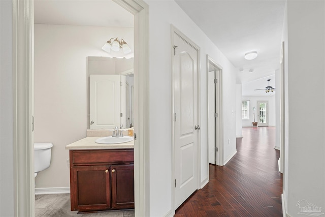 4810 Endeavor Ct, Milton, FL 32570 - hall featuring a sink, dark wood-style flooring, and baseboards