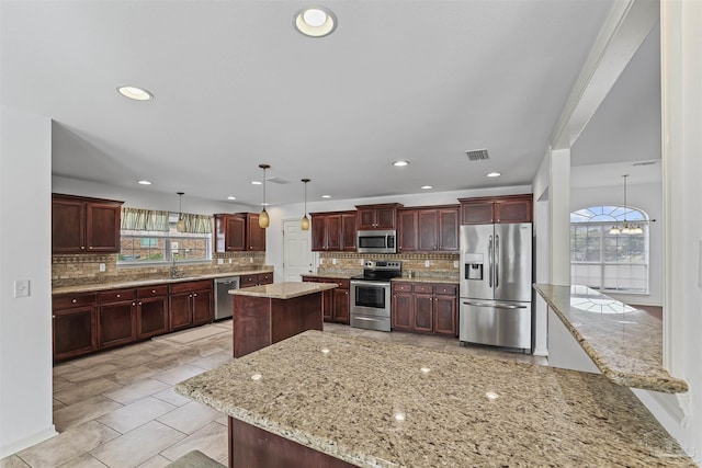 4810 Endeavor Ct, Milton, FL 32570 - kitchen featuring stainless steel appliances, a sink, healthy amount of natural light, tasteful backsplash, and recessed lighting