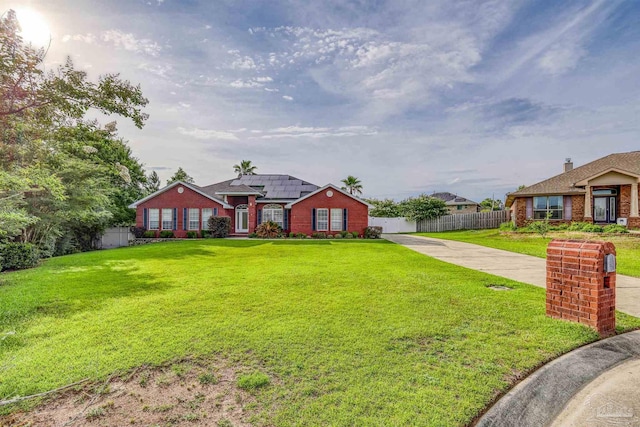 4810 Endeavor Ct, Milton, FL 32570 - view of front of property with concrete driveway, roof mounted solar panels, and brick siding