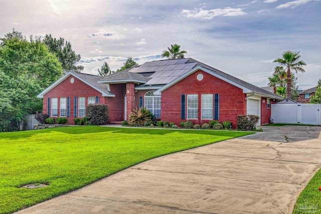 4810 Endeavor Ct, Milton, FL 32570 - ranch-style house with brick siding, concrete driveway, solar panels, and a gate