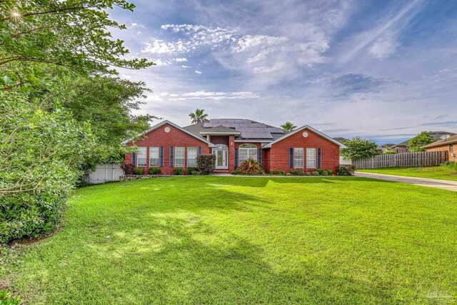 4810 Endeavor Ct, Milton, FL 32570 - view of front of house featuring solar panels and brick siding