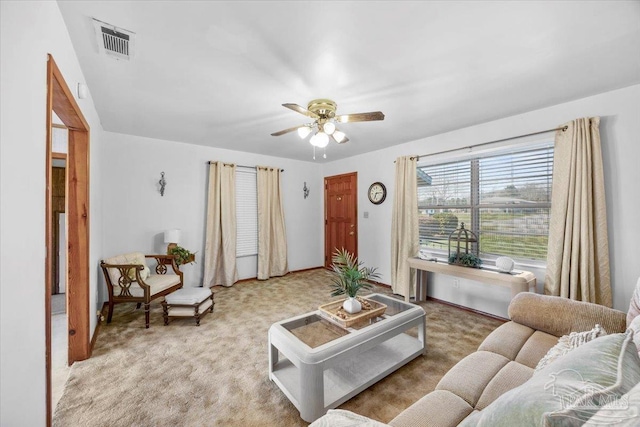 carpeted living room with ceiling fan