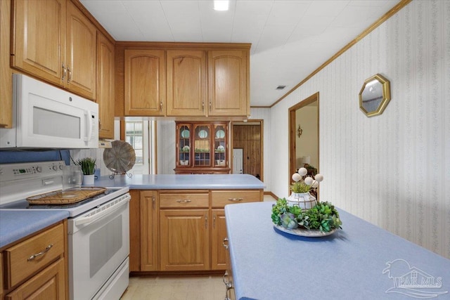 kitchen with white appliances and crown molding