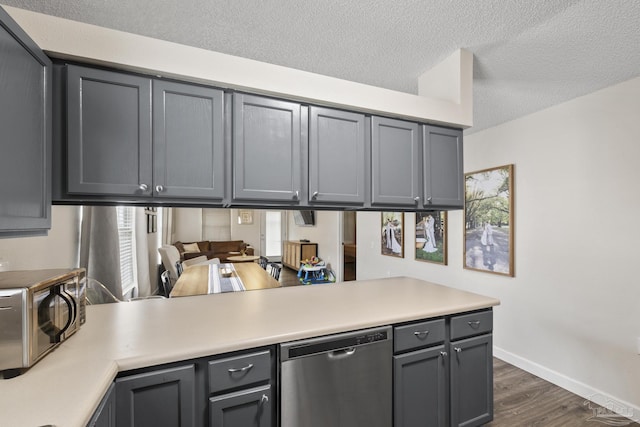5576 Shadow Shore Pl, Gulf Breeze, FL 32563 - kitchen featuring dishwasher, light countertops, dark wood-style floors, a textured ceiling, and gray cabinetry