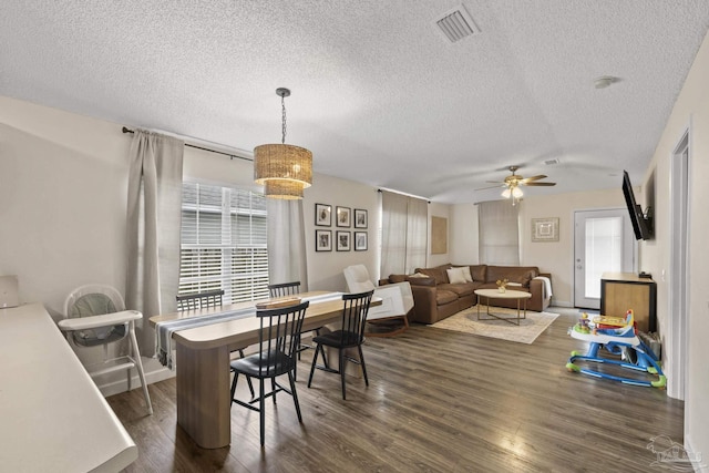 5576 Shadow Shore Pl, Gulf Breeze, FL 32563 - dining room featuring a ceiling fan, dark wood-type flooring, and a textured ceiling