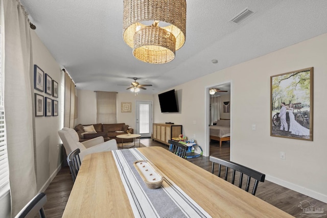5576 Shadow Shore Pl, Gulf Breeze, FL 32563 - dining area featuring a ceiling fan, dark wood-style floors, a chandelier, and a textured ceiling