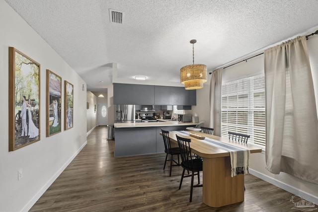 5576 Shadow Shore Pl, Gulf Breeze, FL 32563 - dining area with a textured ceiling and dark wood-style flooring