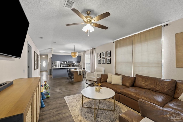 5576 Shadow Shore Pl, Gulf Breeze, FL 32563 - living room with a textured ceiling, dark wood finished floors, ceiling fan, and vaulted ceiling