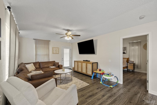 5576 Shadow Shore Pl, Gulf Breeze, FL 32563 - living room featuring a textured ceiling, ceiling fan, and dark wood finished floors