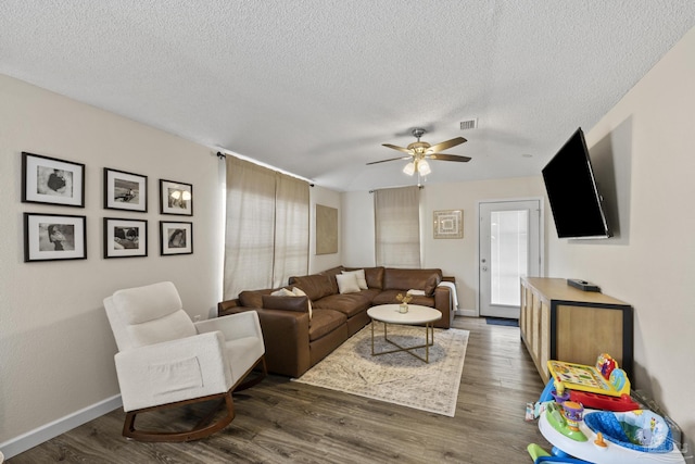 5576 Shadow Shore Pl, Gulf Breeze, FL 32563 - living area with dark wood finished floors, ceiling fan, and a textured ceiling