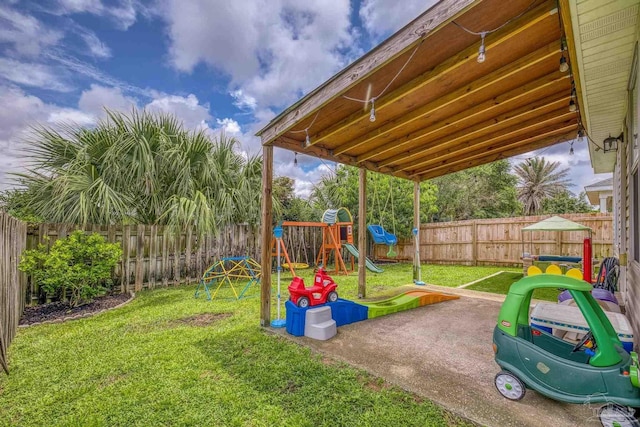5576 Shadow Shore Pl, Gulf Breeze, FL 32563 - fenced backyard with a playground and a patio area