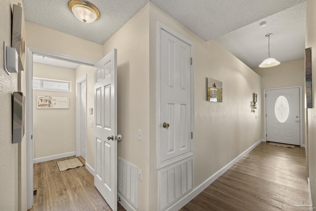 5576 Shadow Shore Pl, Gulf Breeze, FL 32563 - foyer entrance with wood finished floors and a textured ceiling