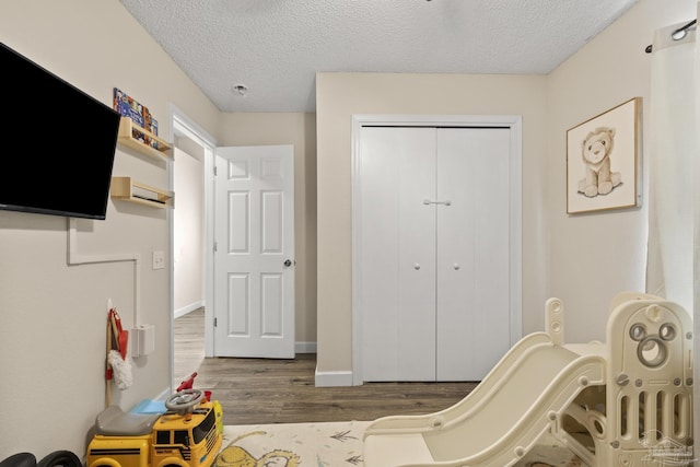 5576 Shadow Shore Pl, Gulf Breeze, FL 32563 - game room featuring wood finished floors and a textured ceiling