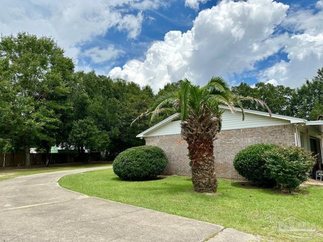 view of property exterior with a lawn