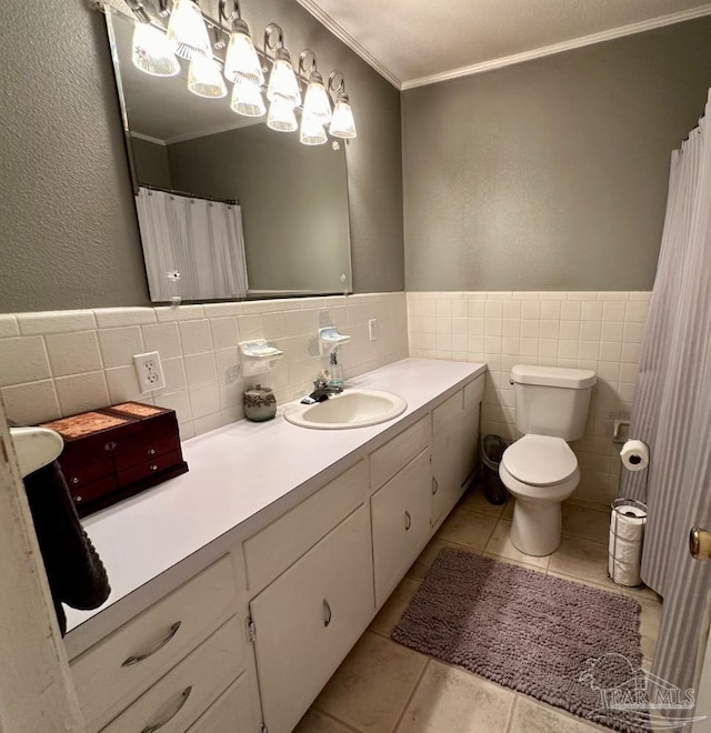 bathroom featuring vanity, tile patterned flooring, ornamental molding, and tile walls