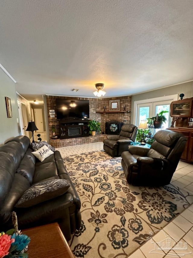 tiled living room with brick wall, a brick fireplace, and a textured ceiling