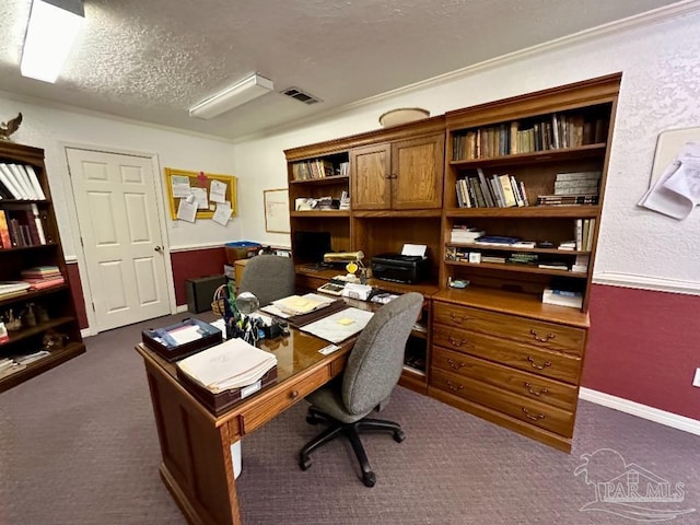 carpeted office space featuring a textured ceiling