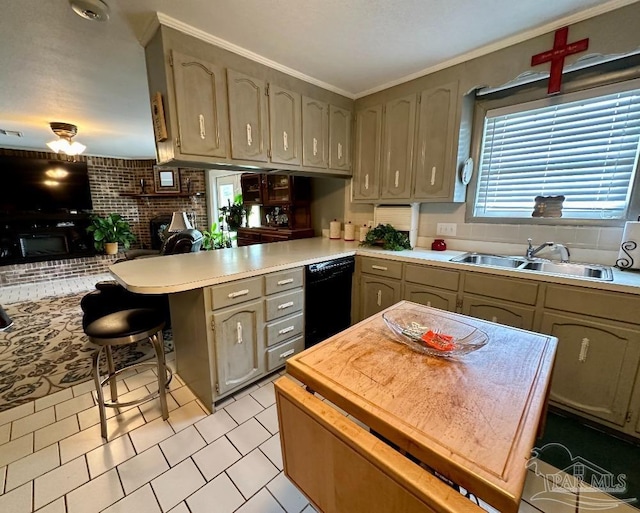 kitchen featuring a breakfast bar, black dishwasher, sink, kitchen peninsula, and a brick fireplace