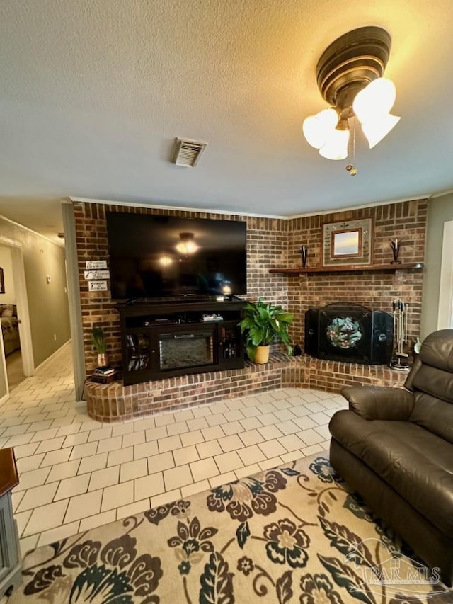 living room featuring tile patterned flooring, a fireplace, and a textured ceiling