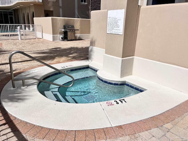 view of swimming pool featuring grilling area and a patio